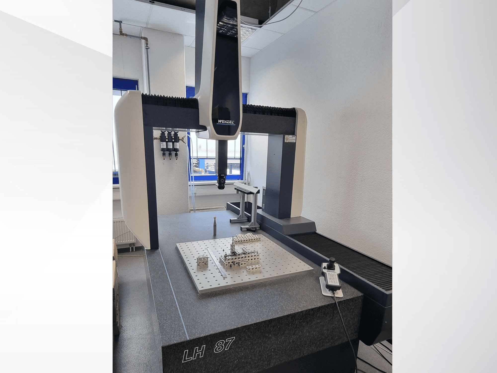 CMM Wenzel LH 87 in un laboratorio, vista frontale con la sonda di misura posizionata su una piastra di precisione e il controller digitale ben visibile.