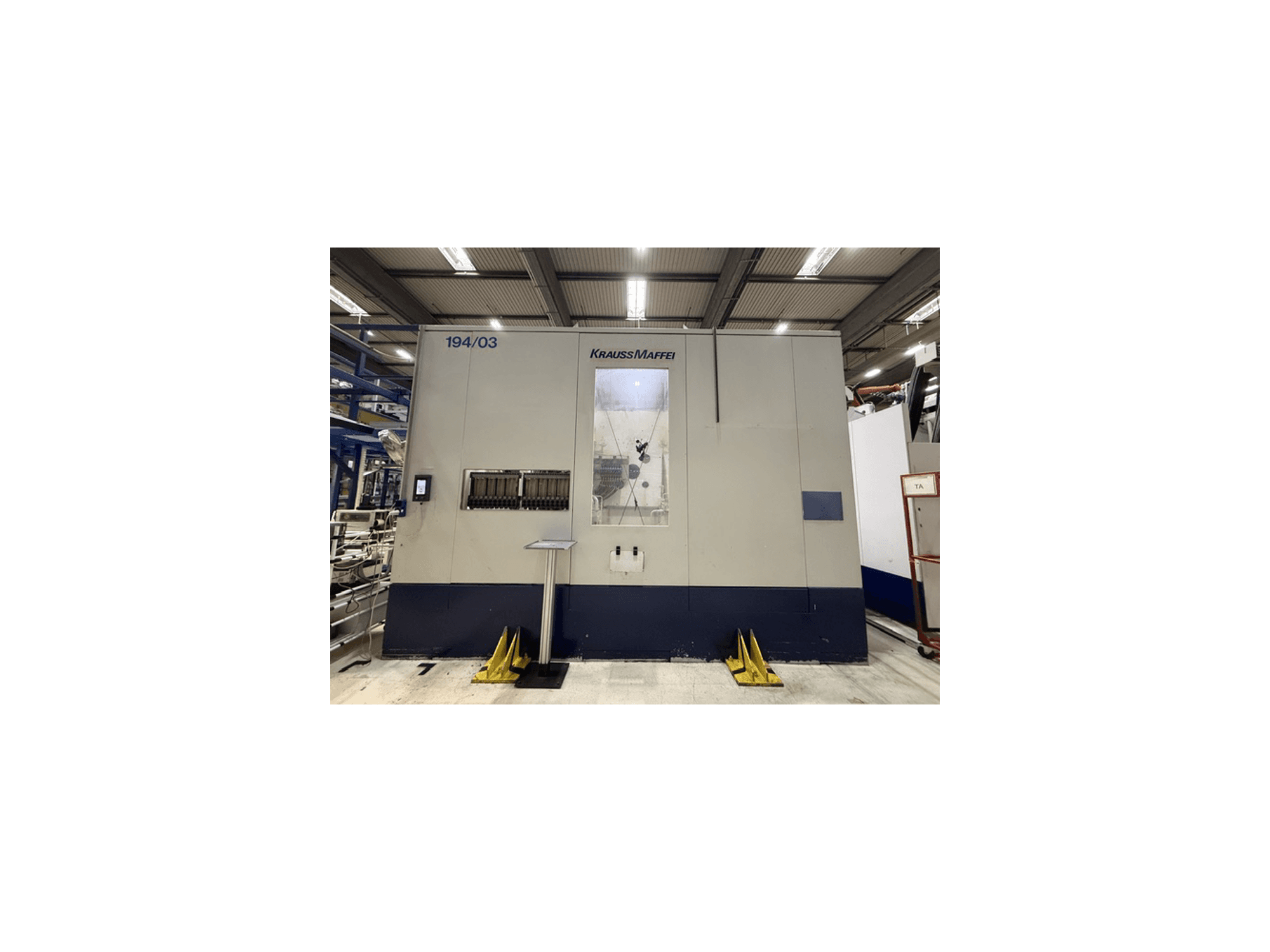 Pressa a iniezione idraulica Krauss Maffei 4000-24500 MC, vista frontale che mostra il pannello di controllo e l'area operativa.