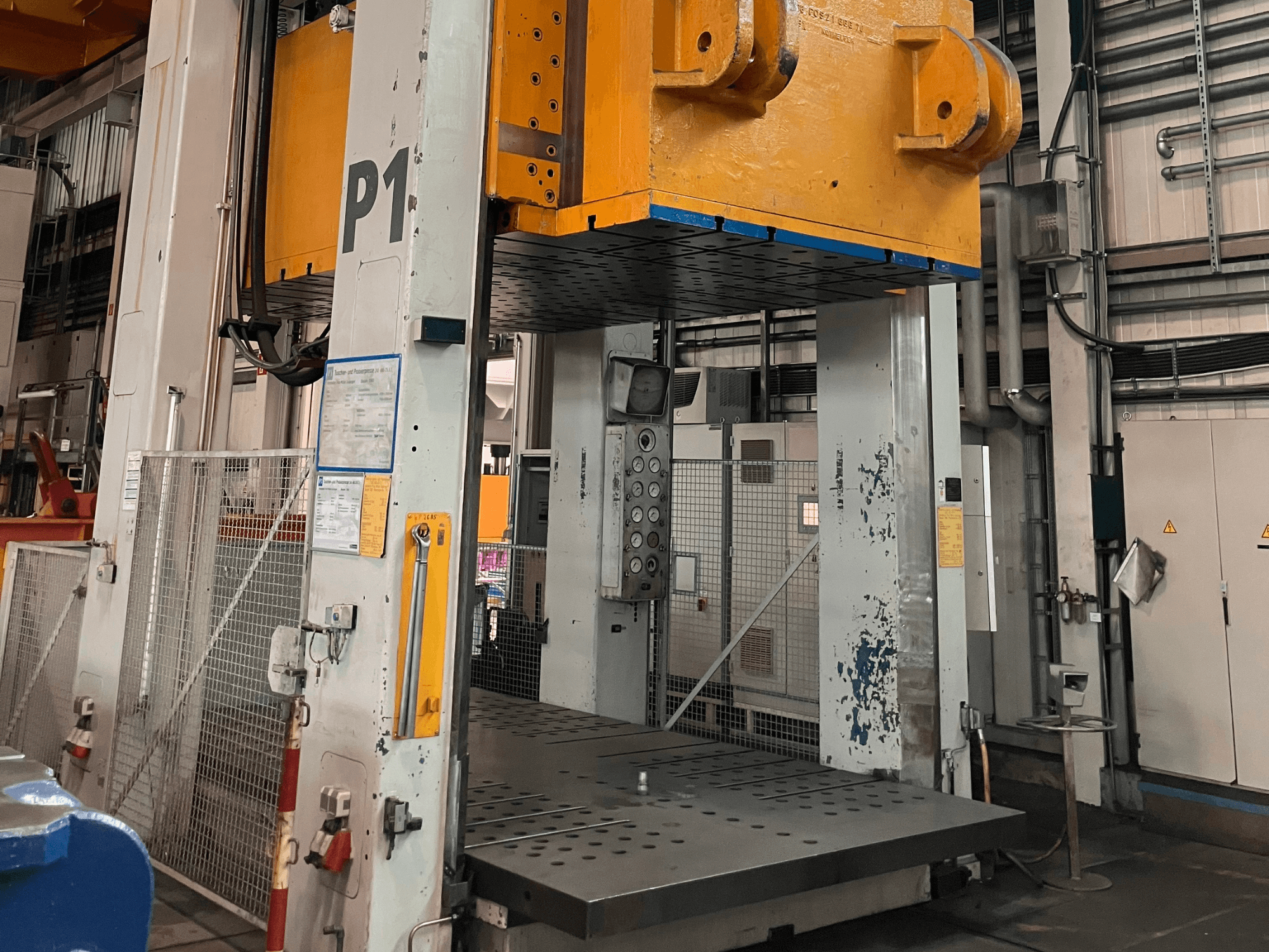 Pressa idraulica FRITZ MULLER ZAE 400-25.1.1, vista frontale, che mostra il pannello di controllo e l'ampia piattaforma di pressatura in un contesto industriale.