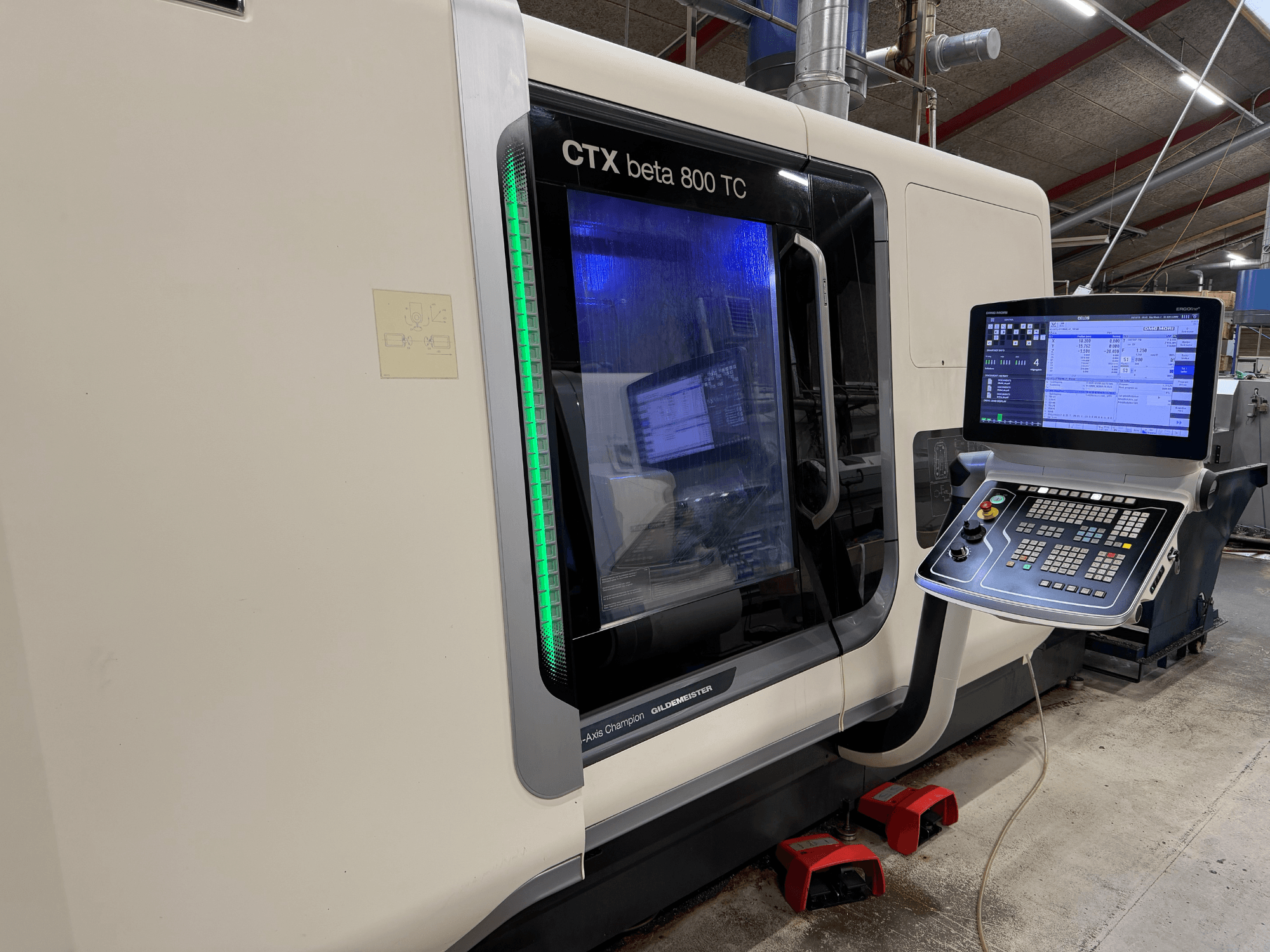 Macchina CNC CTX beta 800 TC in vista laterale, con pannello di controllo digitale e indicatore di sicurezza verde illuminato.