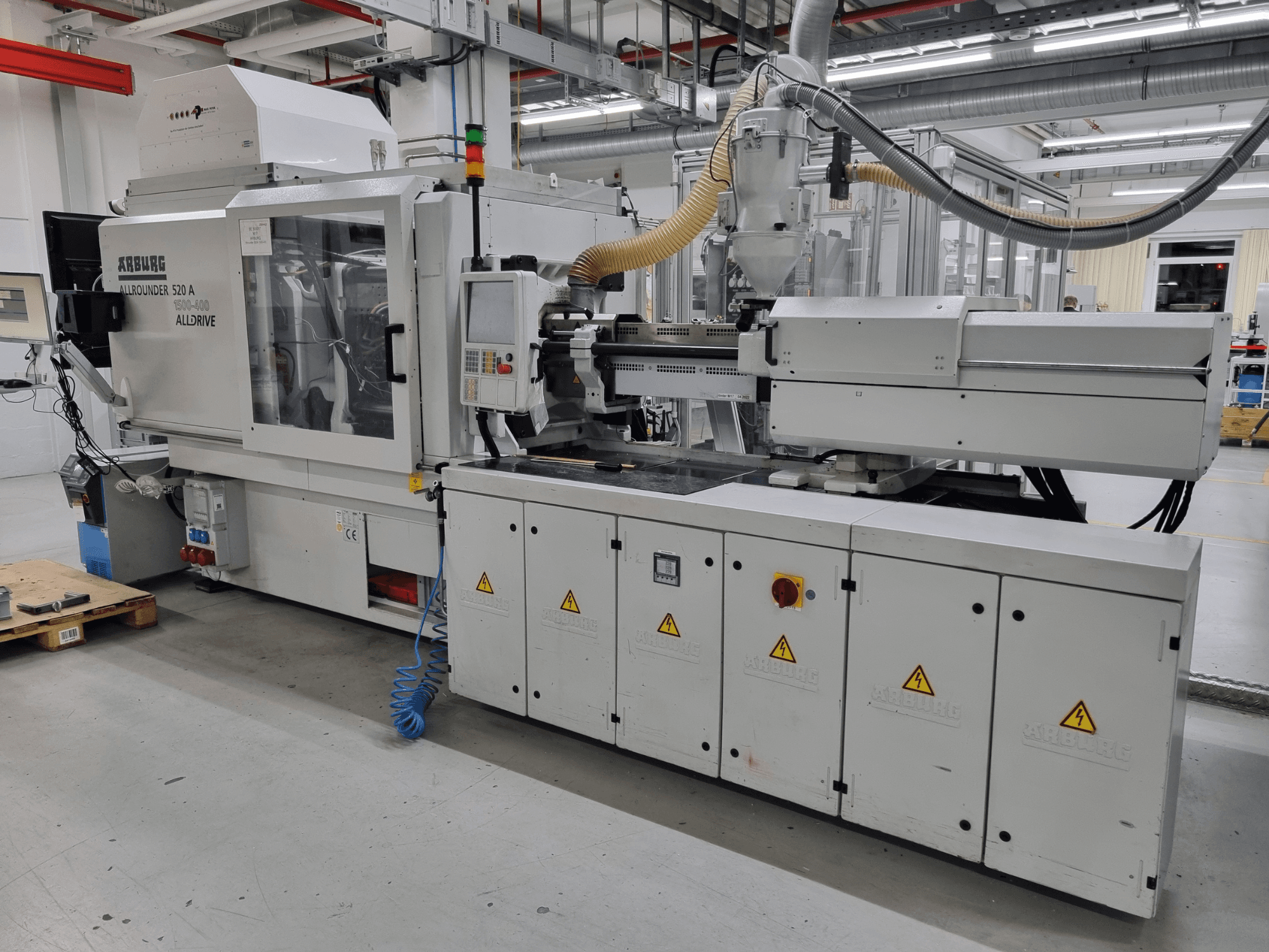 Macchina ad iniezione Arburg Allrounder 520 A, vista laterale, che mostra il pannello di controllo e le caratteristiche di sicurezza.