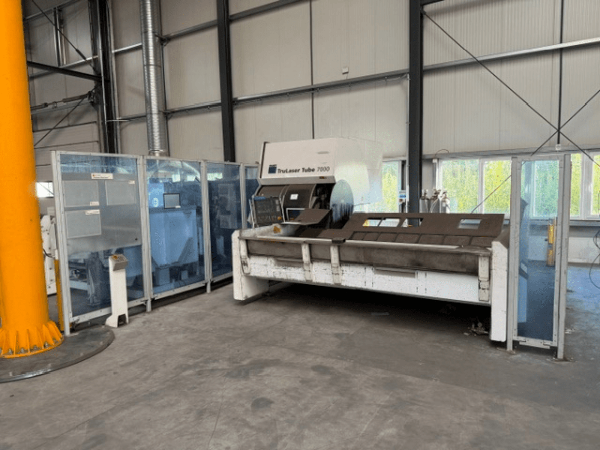 TruLaser Tube 7000 di TRUMPF, vista frontale di una macchina per il taglio di tubi in un ambiente industriale ben illuminato, con i comandi operativi ben visibili.
