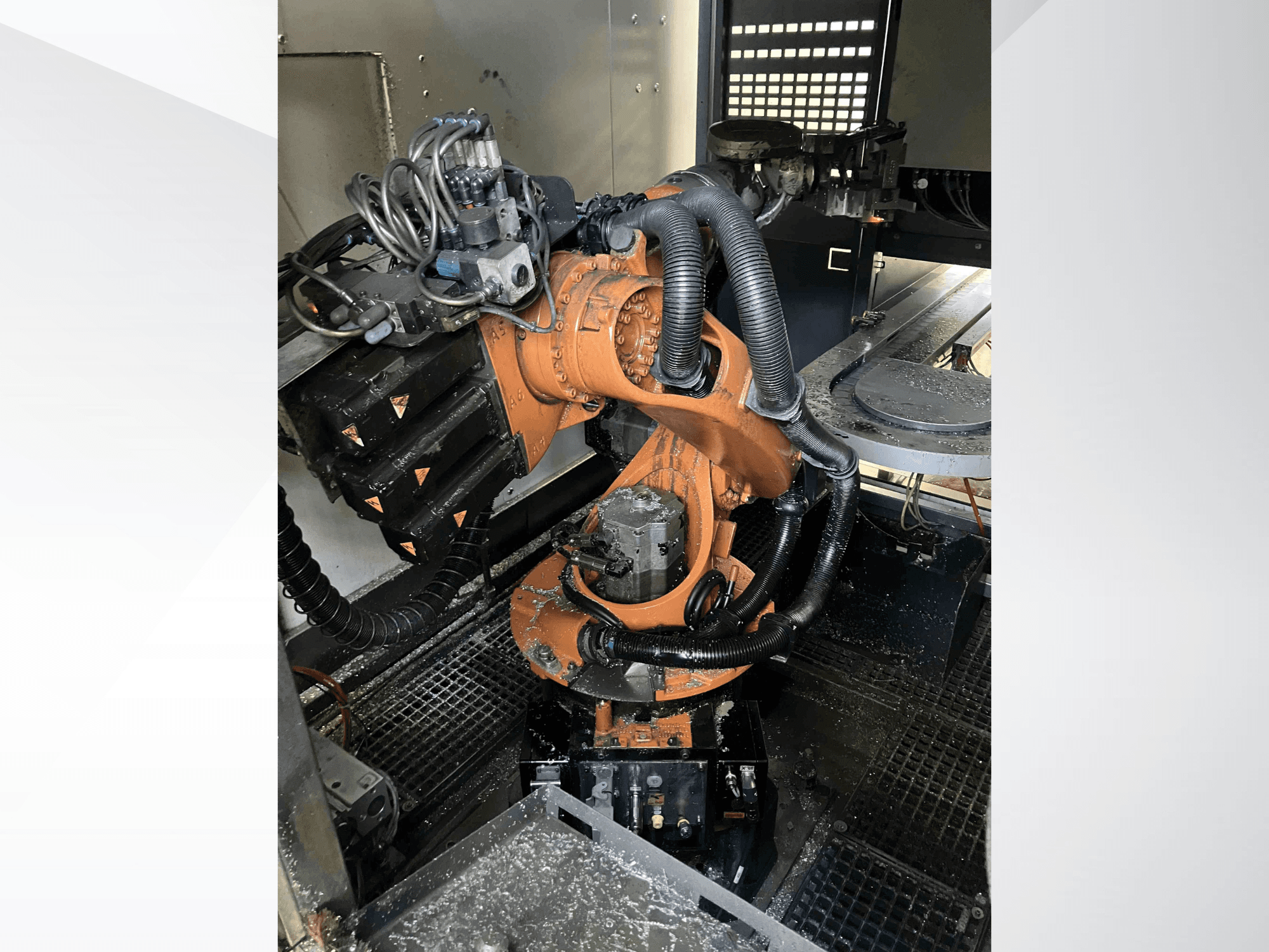 Braccio robotico KUKA KR 16 visto dall'alto, che mostra i componenti meccanici e il cablaggio in un ambiente di officina.