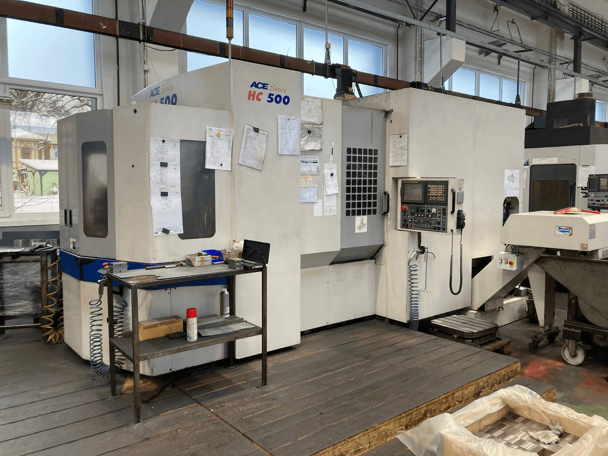 Centro di lavoro orizzontale DOOSAN ACE HC-500, vista frontale; dispone di pannello di controllo, magazzino utensili multipli e impostazione industriale.