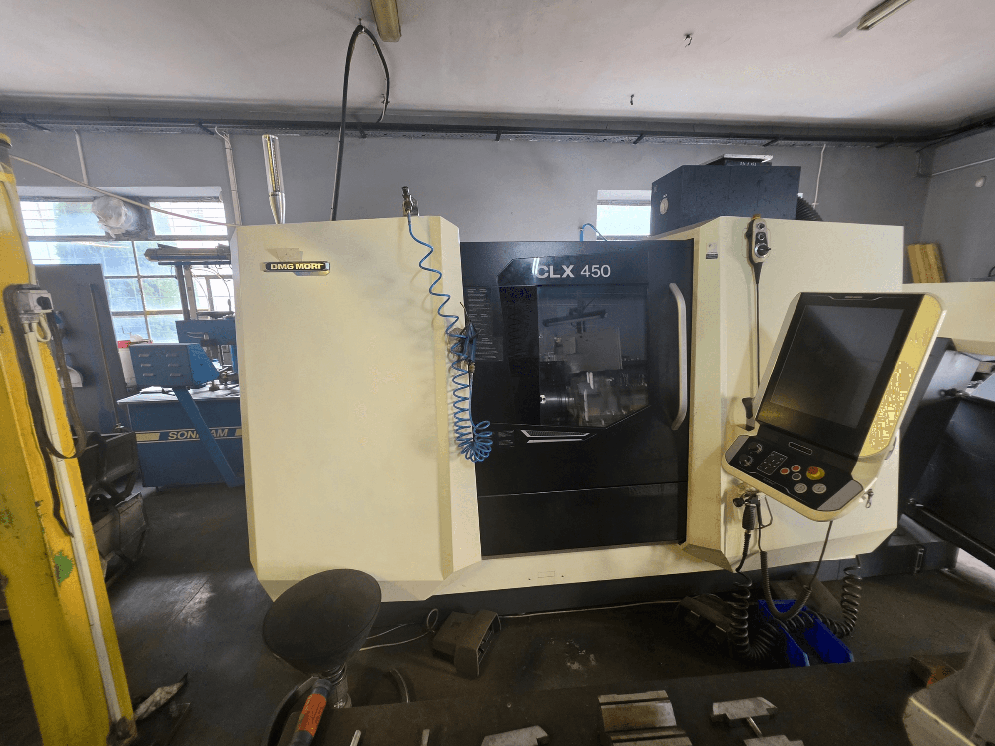 Tornio orizzontale DMG MORI CLX 450 V6 visto frontalmente, con pannello di controllo e marchio ben visibile.