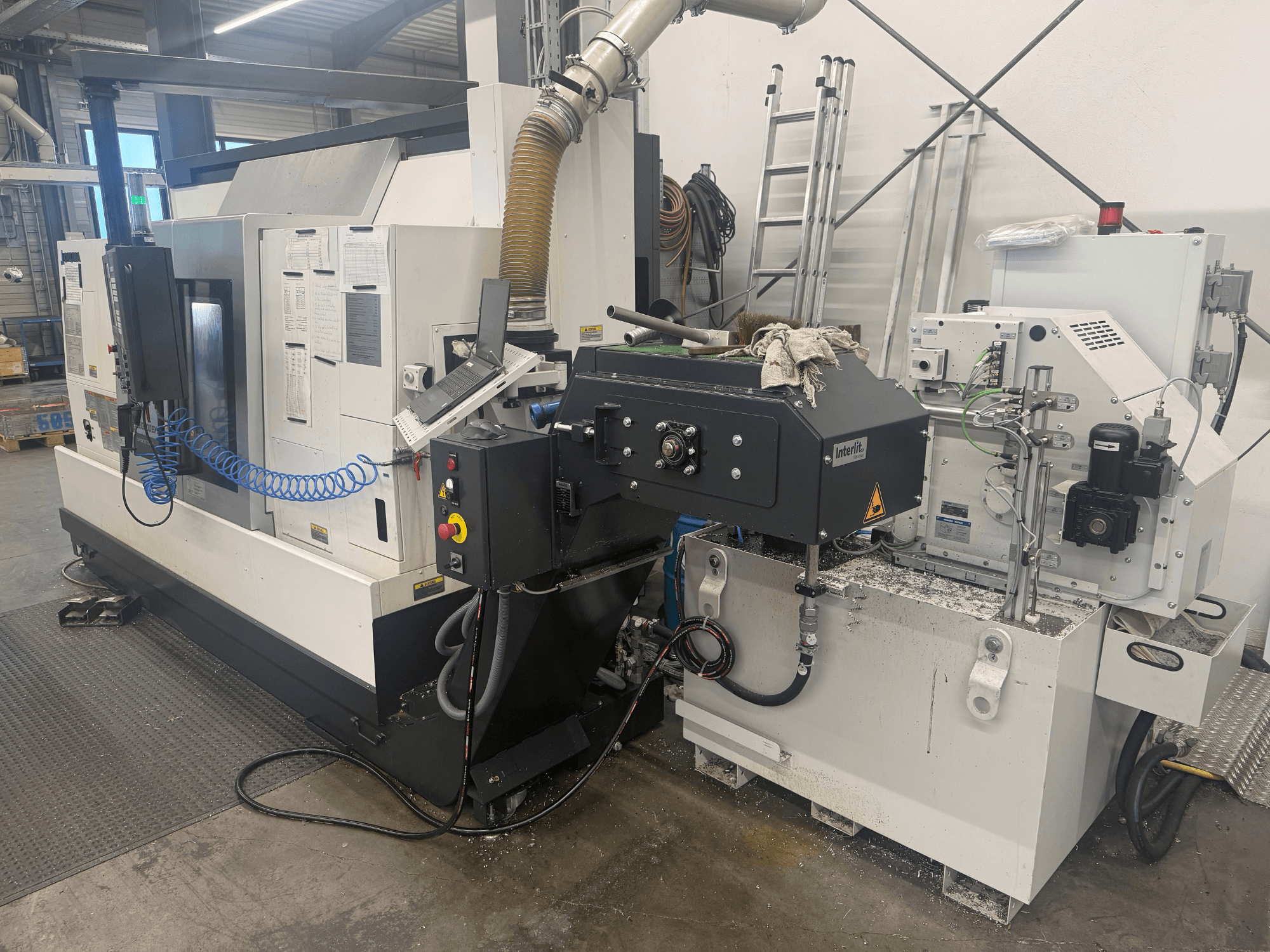 Tornio orizzontale Okuma LB3000II-MYC 950, vista frontale, con pannello di controllo e sistema di raffreddamento.