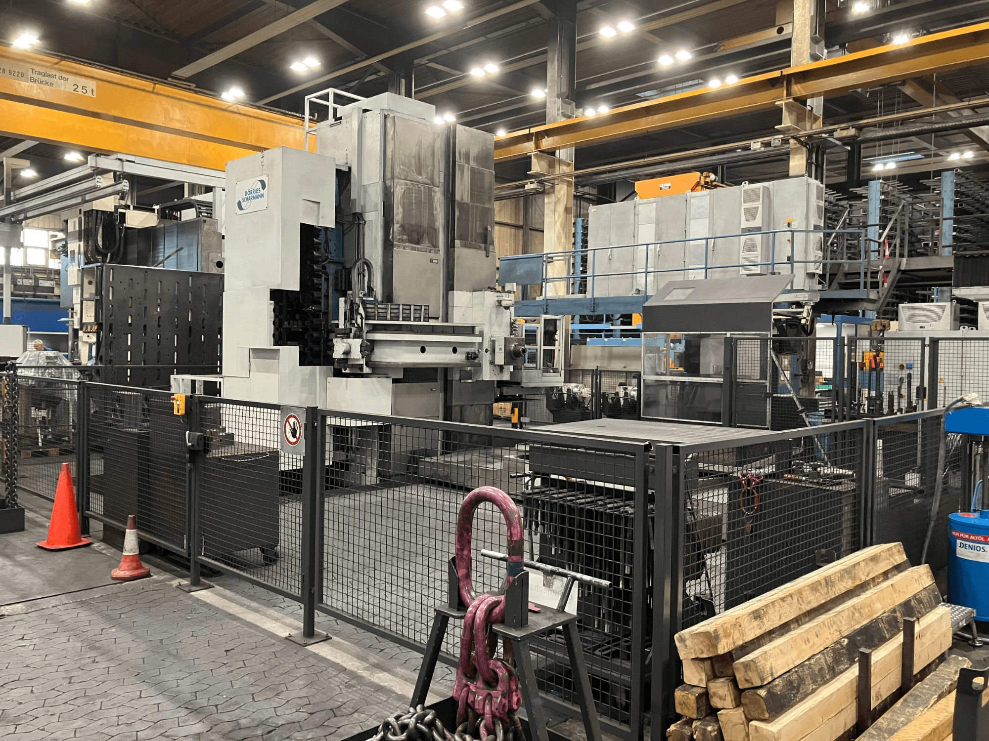 Fresatrice DÖRRIES SCHARMANN Heavycut 1.2 TDV4 in ambiente di fabbrica, vista laterale con barriere di sicurezza e utensili nelle vicinanze.