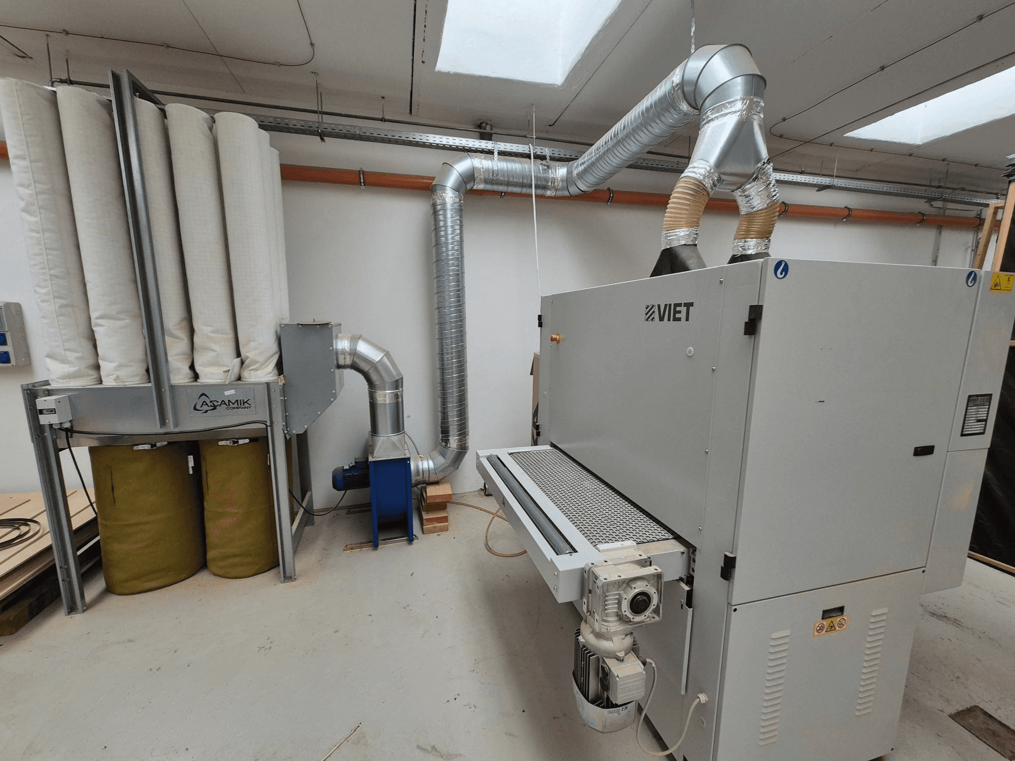 Sistema di aspirazione Viet con filtri cilindrici e scarico argentato, visto frontalmente in un'officina.