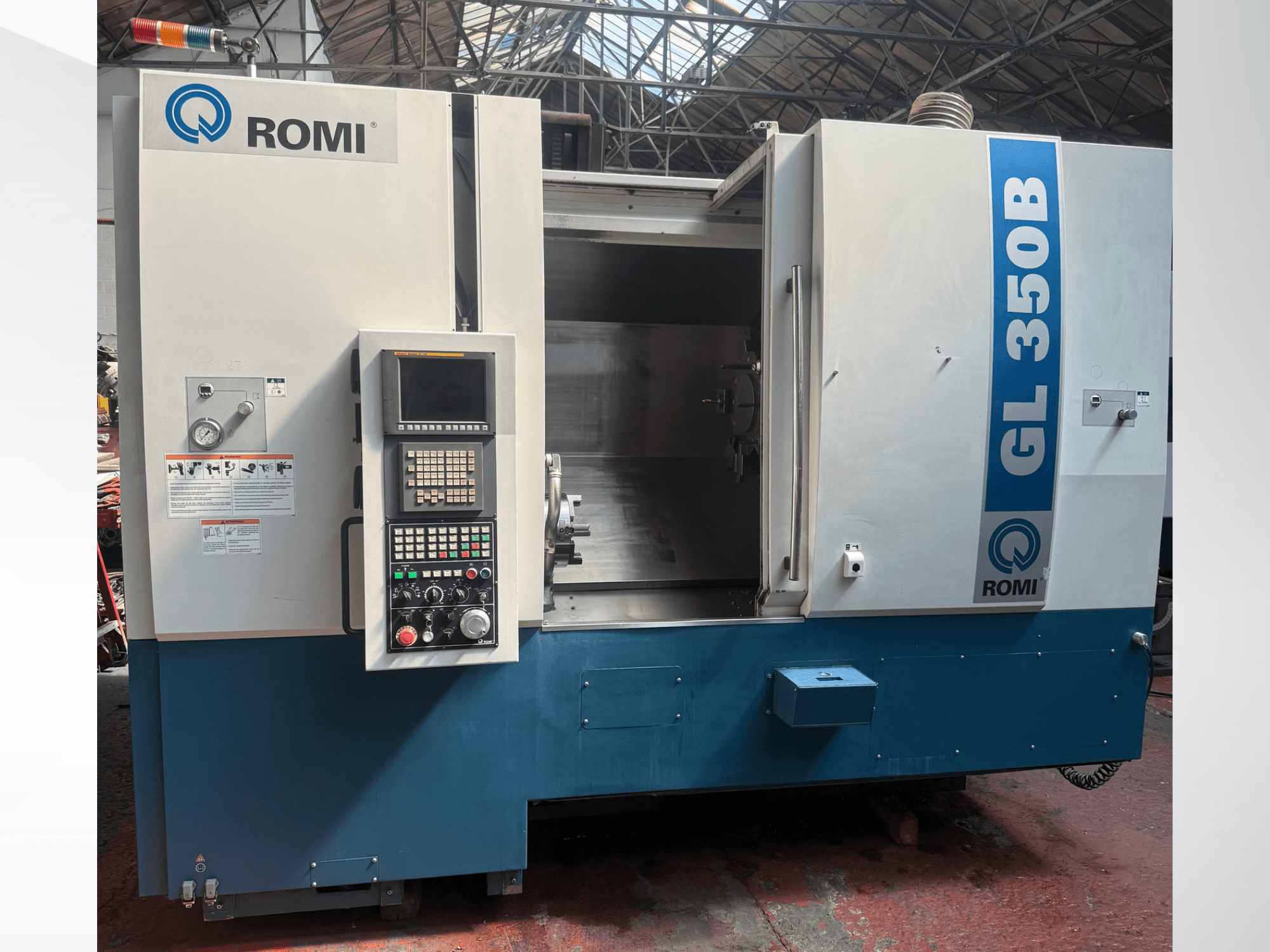 Vista frontale del tornio orizzontale Romi GL 350B, che mostra il pannello di controllo e l'area di lavoro aperta.
