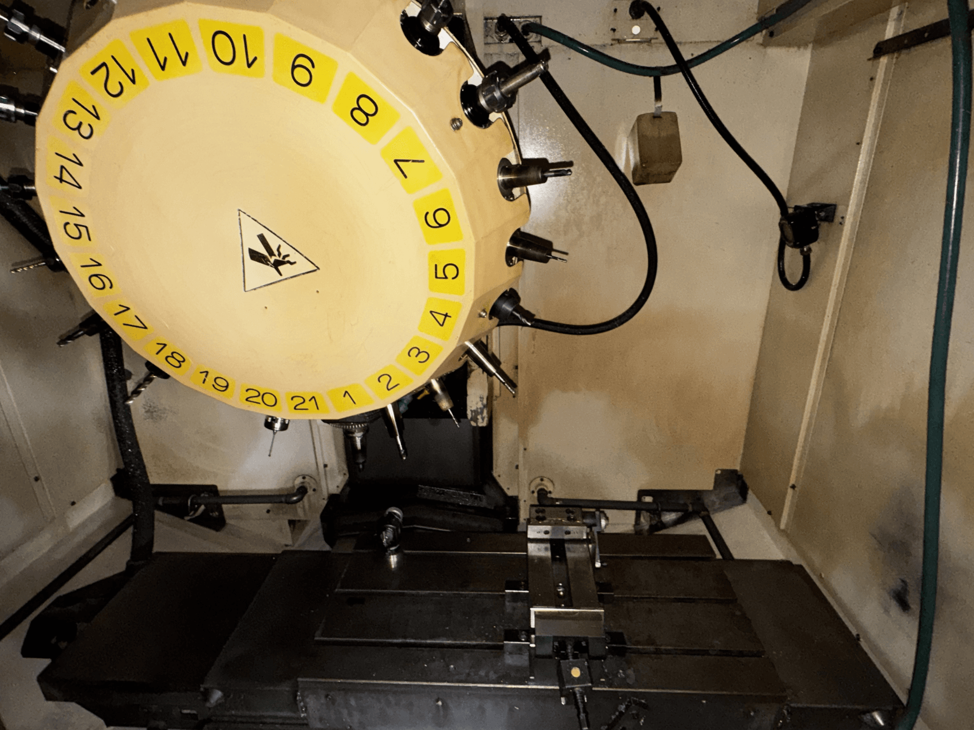 Centro di lavoro verticale FANUC Robodrill alpha-T21iFL vista interna con carosello utensili e tavola di lavoro visibili.