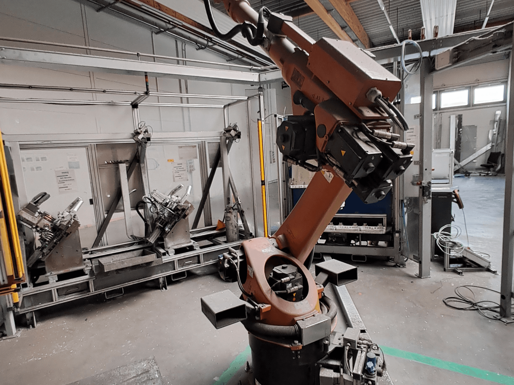 Braccio robotico KUKA KR 30L16-2 in un ambiente industriale, vista laterale, che mostra le articolazioni del braccio e gli strumenti di presa.