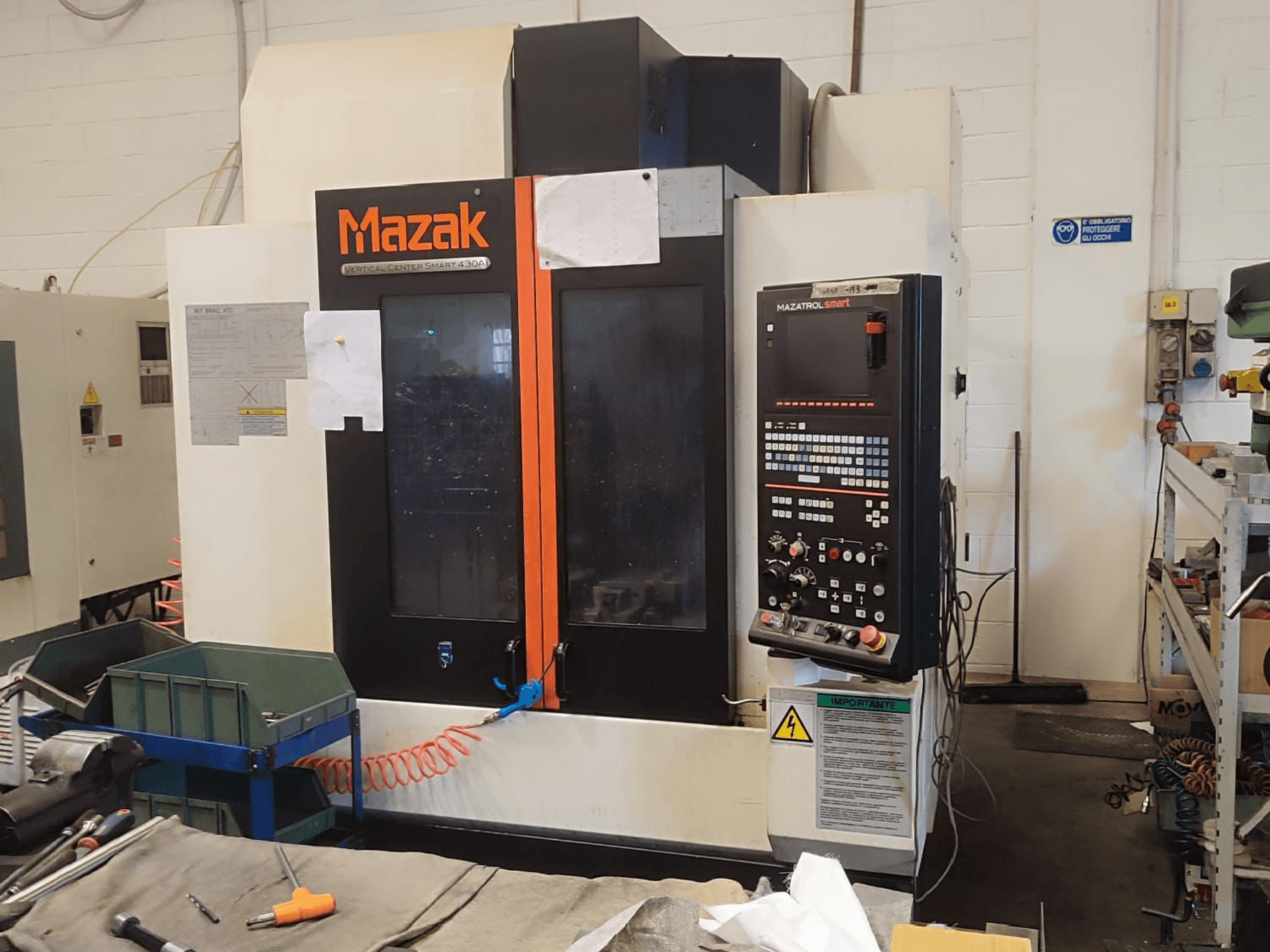 Centro di lavoro verticale Mazak VCS 430A, vista frontale che mostra il pannello di controllo e i dettagli operativi in un'officina.