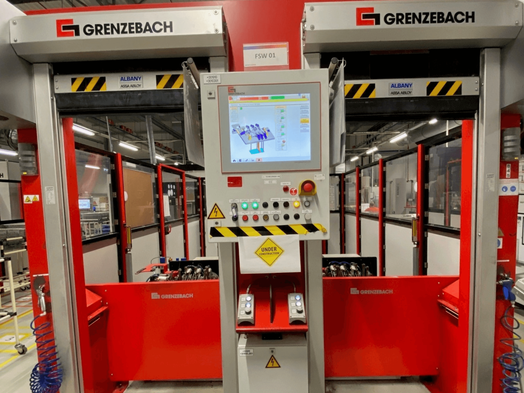 Vista frontale del braccio robotico GRENZEBACH FSW GenRob 01, dotato di un pannello di controllo con touchscreen e vari pulsanti di comando.
