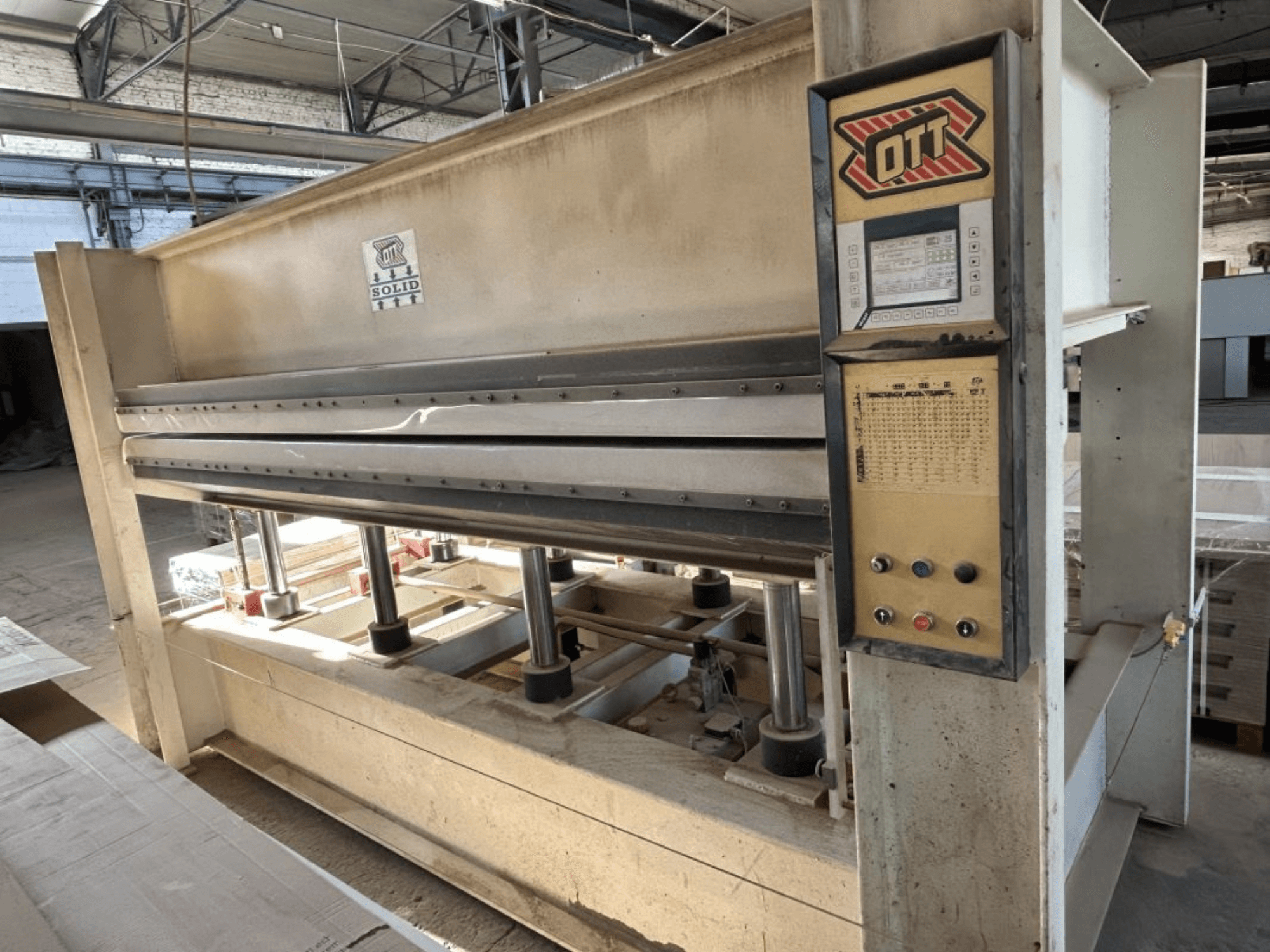 Vista frontale della pressa di laminazione OTT SOLID 16-32, con il pannello di controllo e i componenti idraulici.