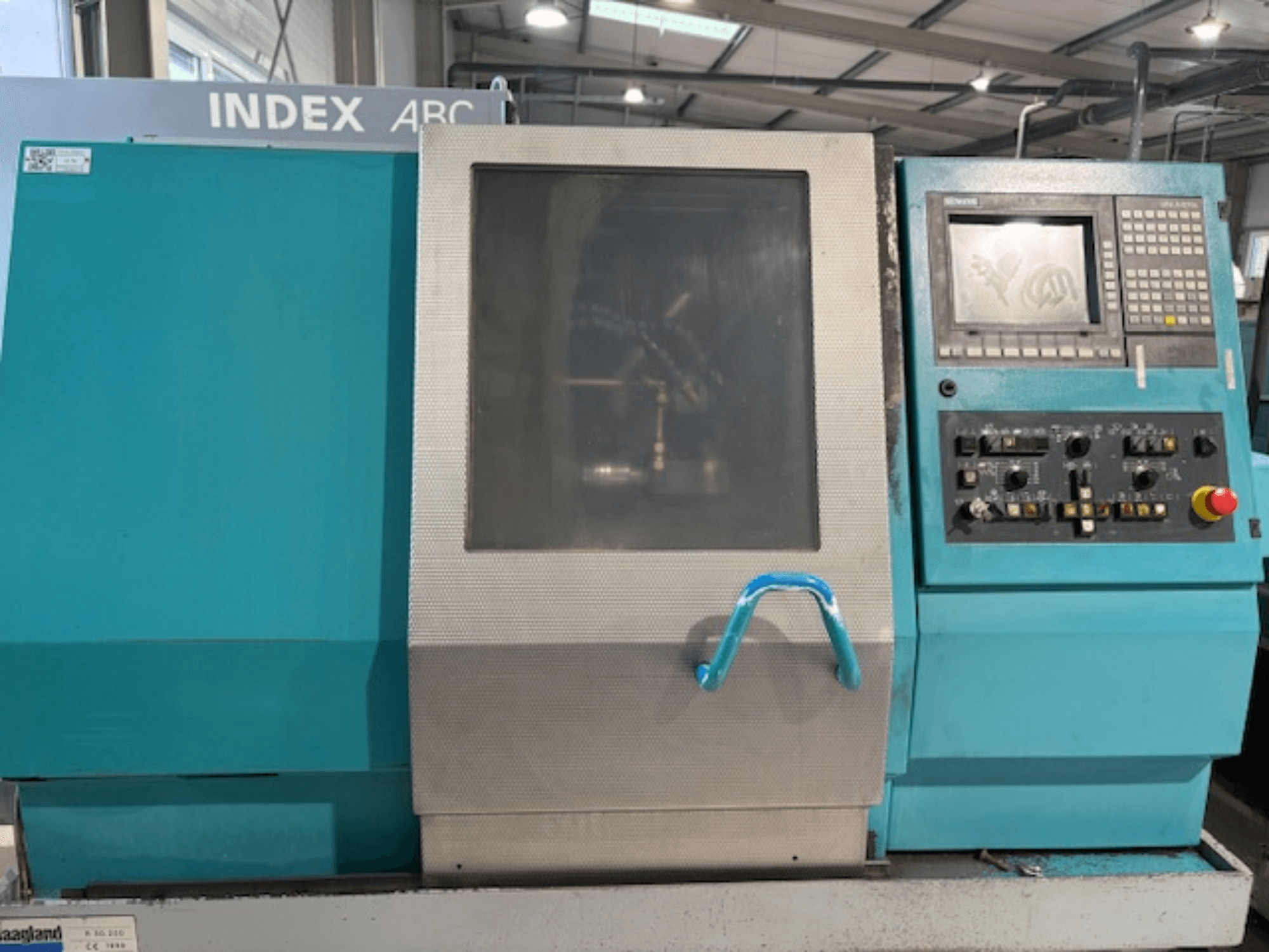 Indice ABC 63 Tornio orizzontale, vista frontale con pannello di controllo, corpo blu e finestra trasparente.