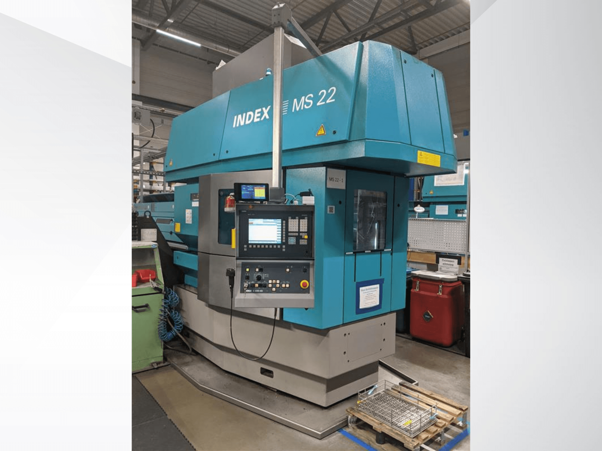 Tornio multimandrino Index MS 22 in ambiente industriale, vista frontale che mostra il pannello di controllo e la carrozzeria blu.