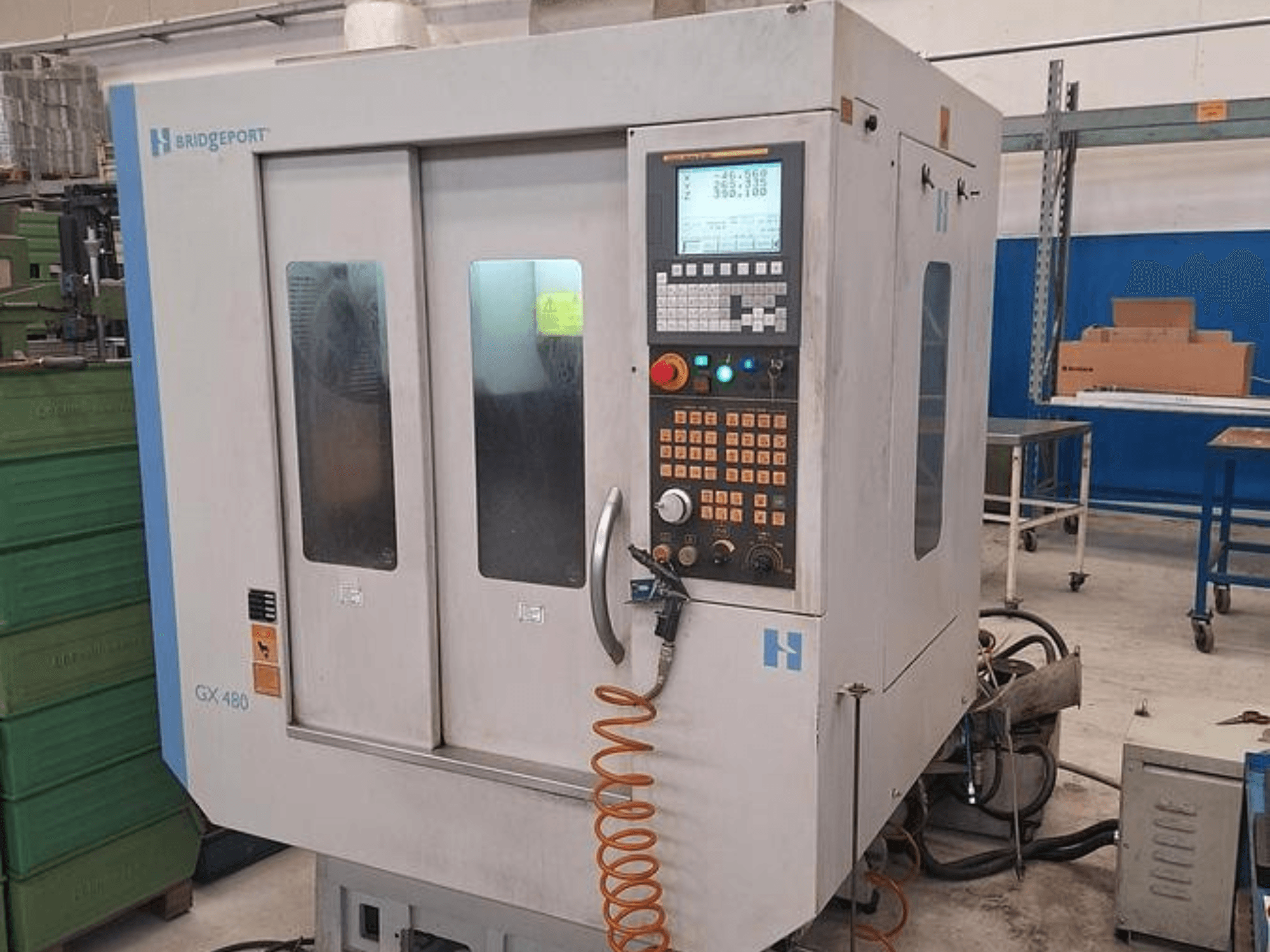 Centro di lavoro verticale Bridgeport GX 480 in vista frontale, con pannello di controllo, doppi sportelli in vetro e tubo flessibile.
