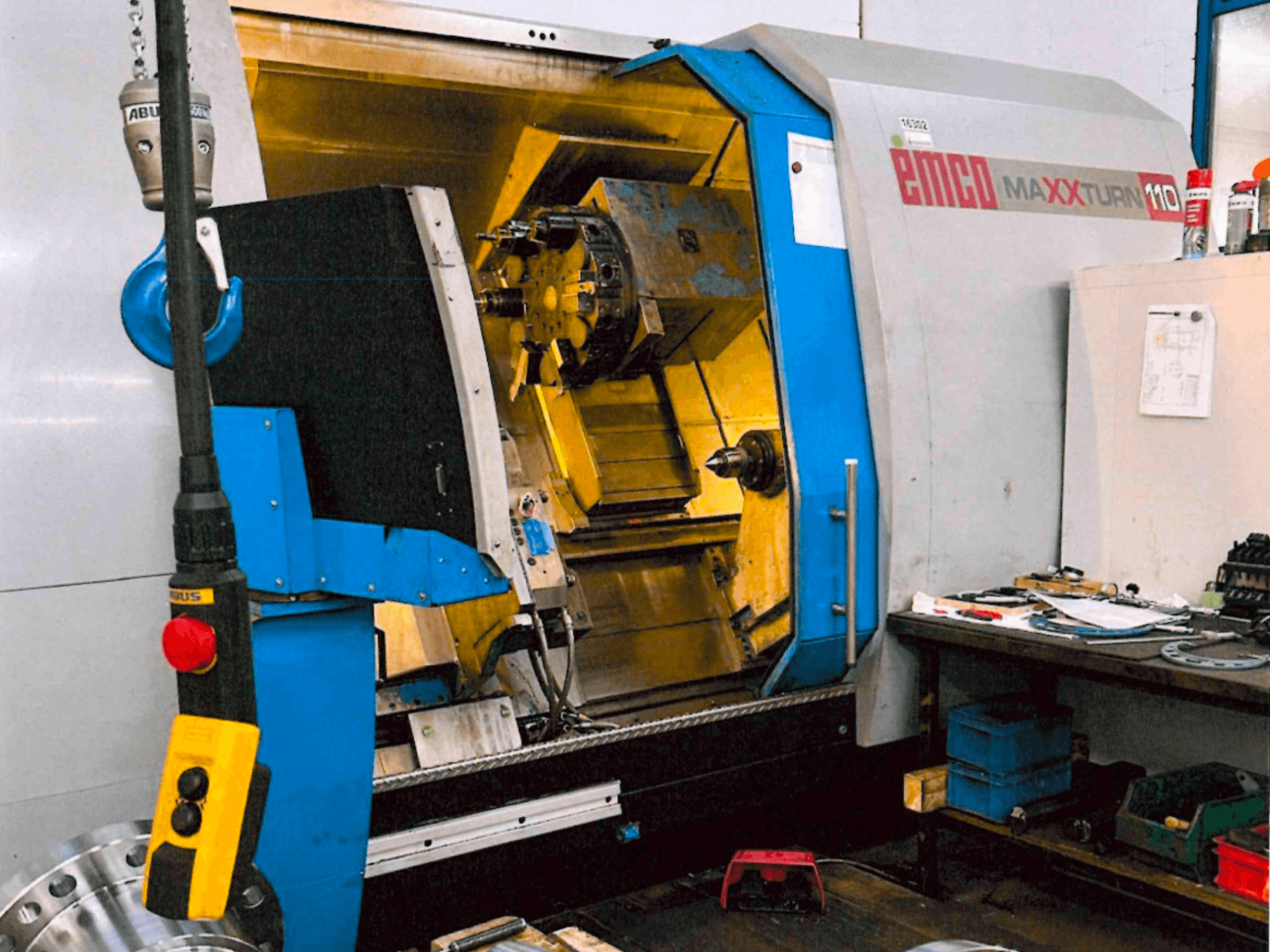 Tornio orizzontale EMCO MAXTURN 110, vista frontale, con i componenti interni e il pannello di controllo, in ambiente di officina.