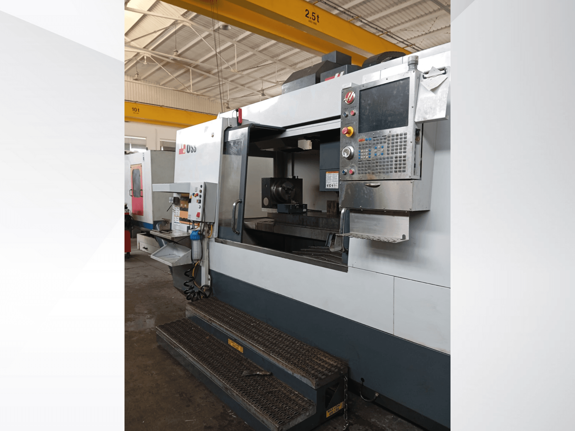 Fresatrice CNC Haas, vista frontale, che mostra il pannello di controllo, l'area di lavoro e i passaggi dettagliati per l'accesso.