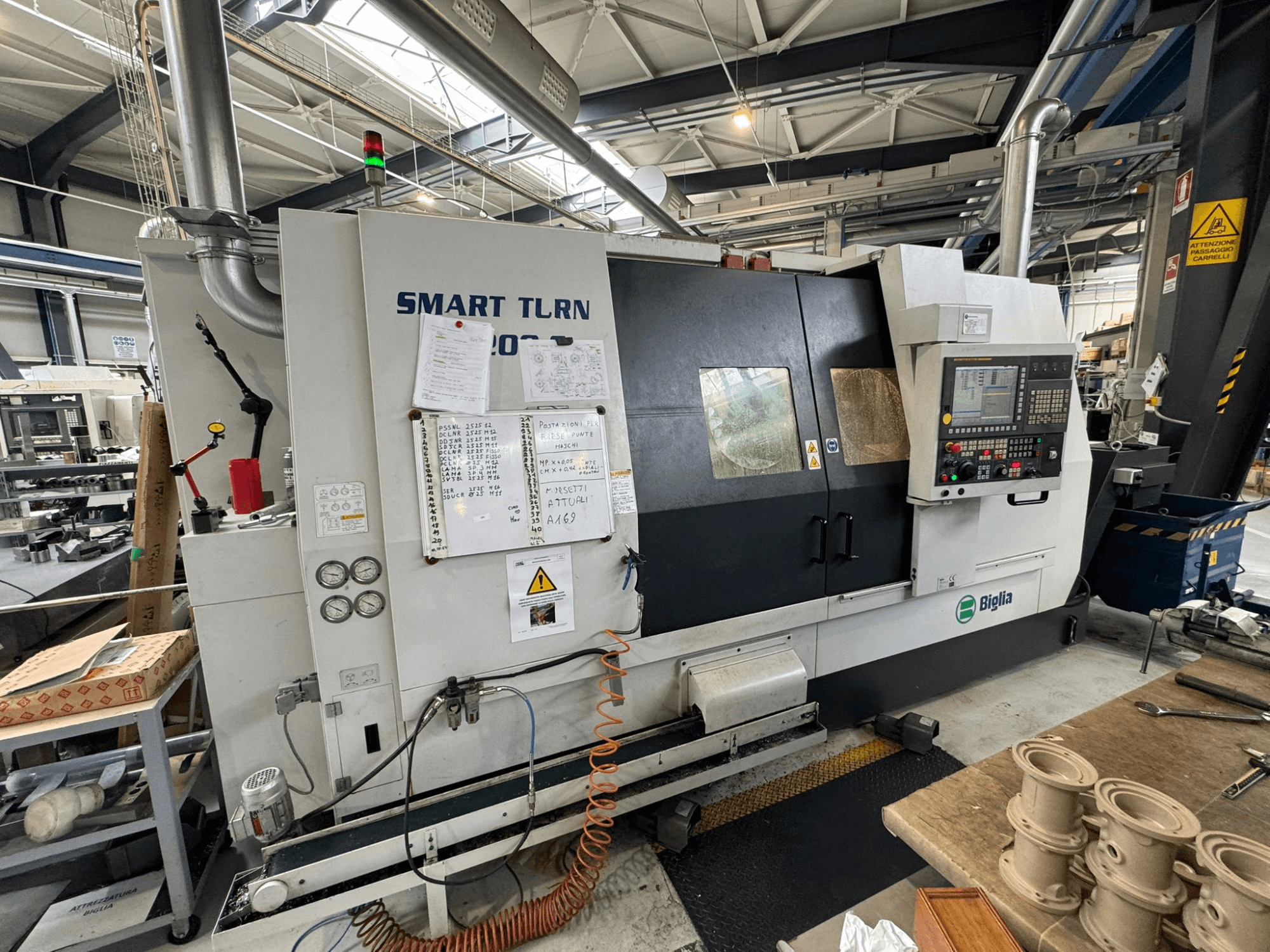 Centro di tornitura Biglia Smart Turn B1200S in un'officina, con pannello di controllo, manometri e indicatori di sicurezza.