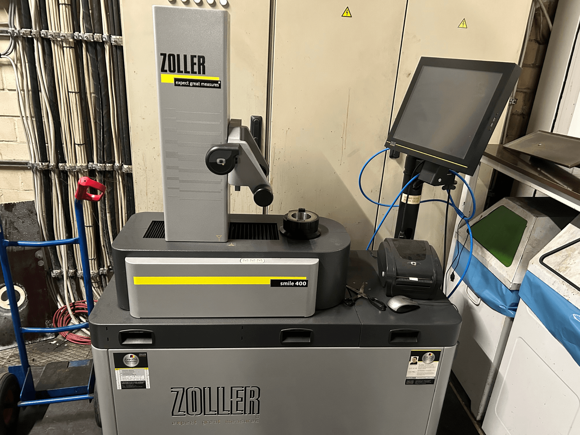Macchina di misura ZOLLER smile 400 in grigio, vista frontale, con touchscreen, portautensili e stampante su un piano di lavoro.